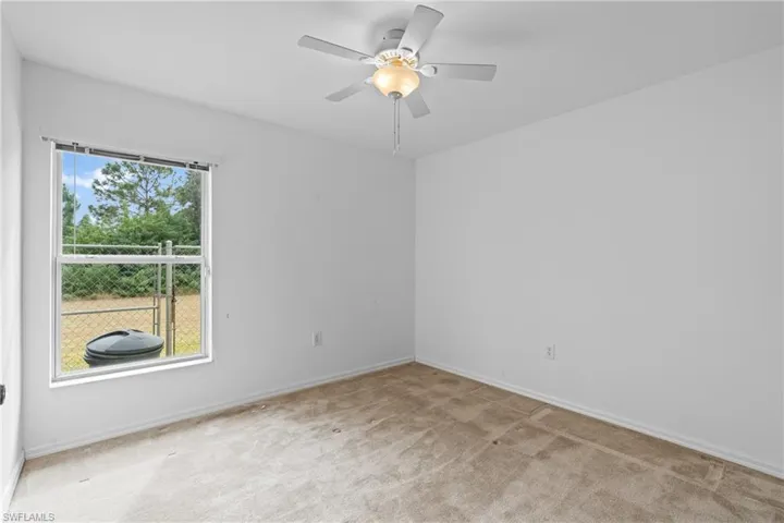 Unfurnished room with carpet flooring and ceiling fan