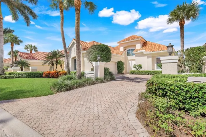 Mediterranean / spanish-style home with a front yard
