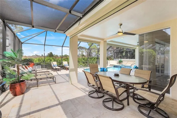 Sunroom / solarium featuring ceiling fan