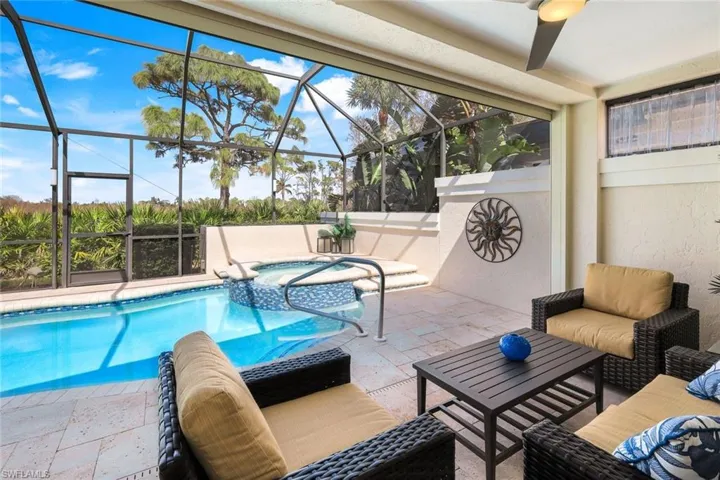 View of pool featuring an in ground hot tub, ceiling fan, a patio area, and a lanai