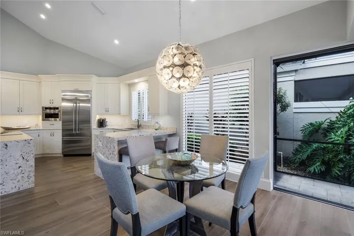 Dining room featuring sink, hardwood / wood-style floors, and a healthy amount of sunlight