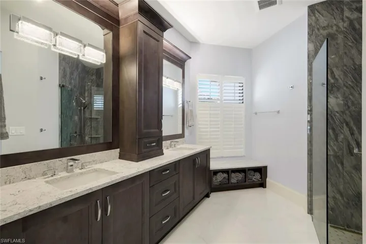 Bathroom featuring vanity and a shower with shower door