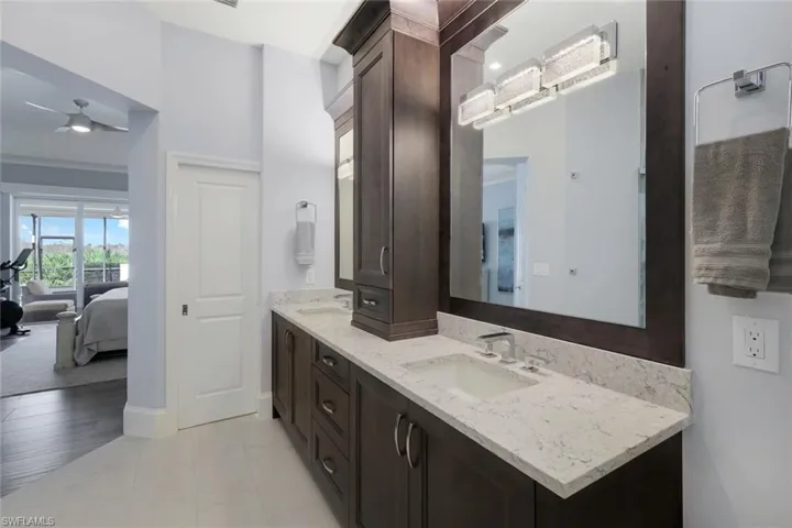 Bathroom with vanity, hardwood / wood-style flooring, and ceiling fan