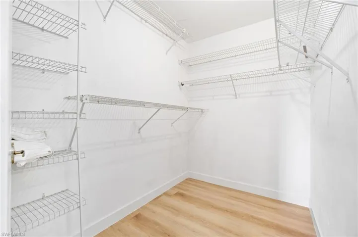 Spacious closet featuring light wood-type flooring