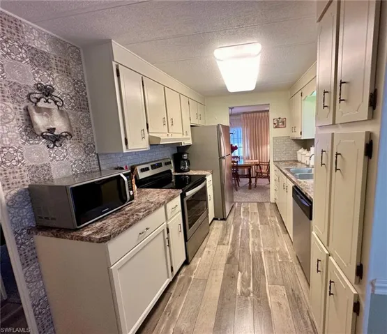 Bright & cheerful Kitchen features a glass-top stove, dishwasher, and microwave.