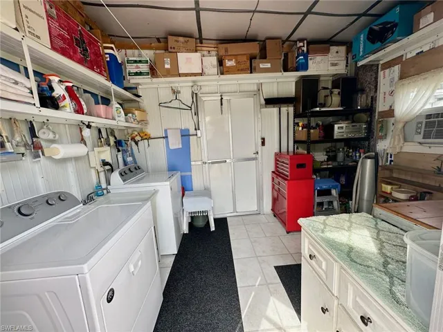 Air-conditioned Laundry Suite with laundry tub, water heater, and included Washer & Dryer conveniently located in the breezeway shed.