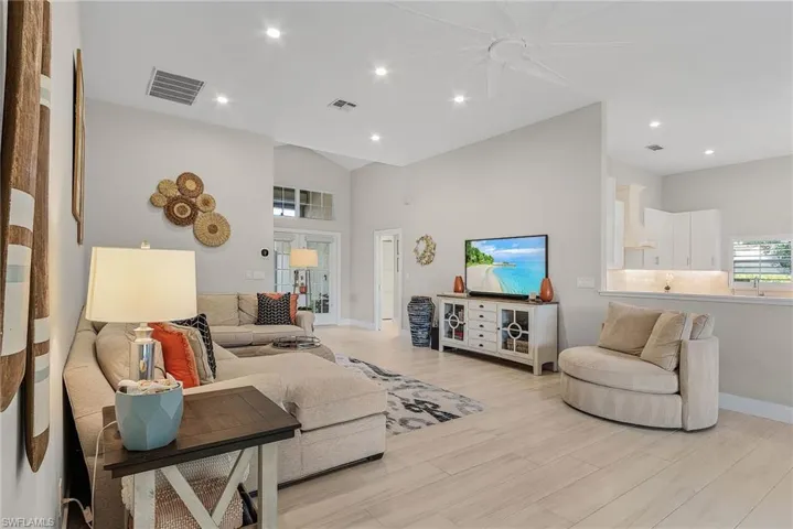 Living room with ceiling fan and light hardwood / wood-style floors