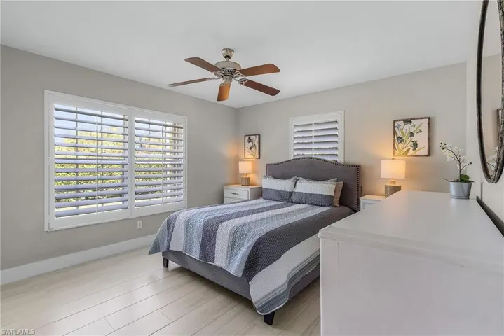 Bedroom with ceiling fan and light hardwood / wood-style flooring