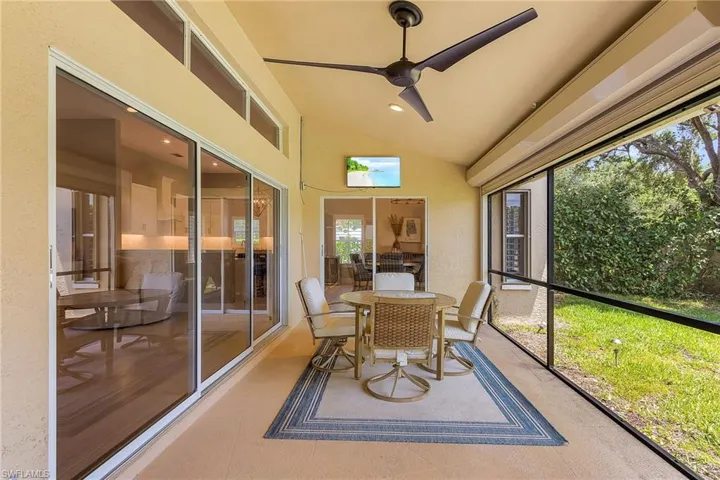 Sunroom / solarium featuring ceiling fan and vaulted ceiling