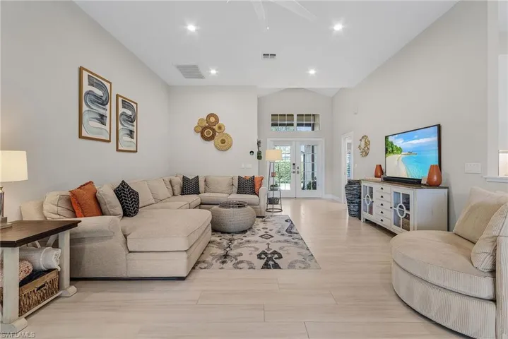 Living room with light hardwood / wood-style floors and french doors