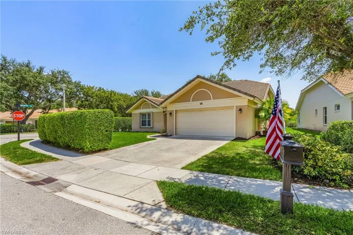 View of front of house featuring a garage and a front yard