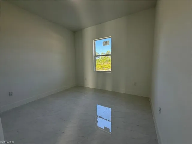 Unfurnished room with baseboards