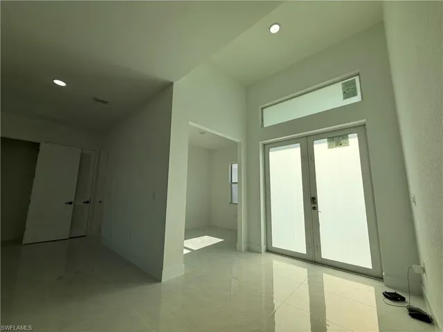 Foyer with french doors and recessed lighting