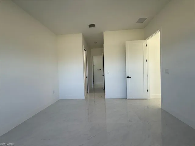 Empty room with light marble finish flooring and baseboards