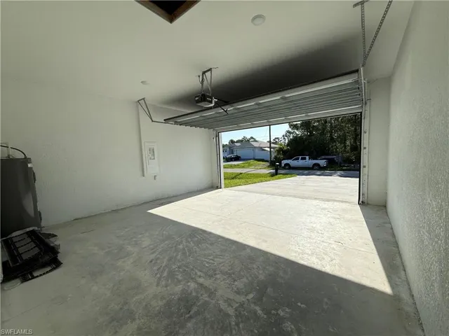 Garage with a textured wall and water heater