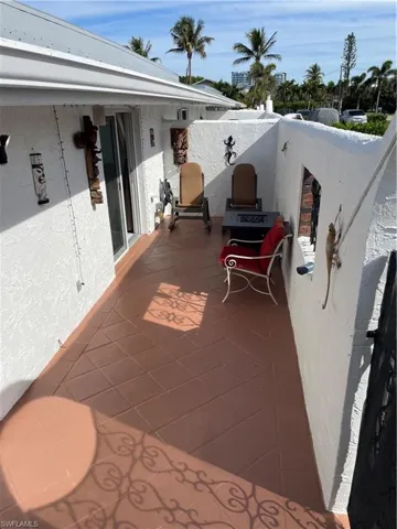 View of patio with a balcony