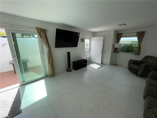 Unfurnished living room featuring a healthy amount of sunlight