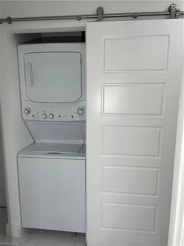 Laundry area featuring stacked washer / drying machine