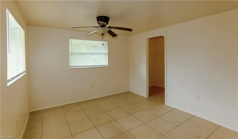 Spare room with light tile patterned floors and ceiling fan