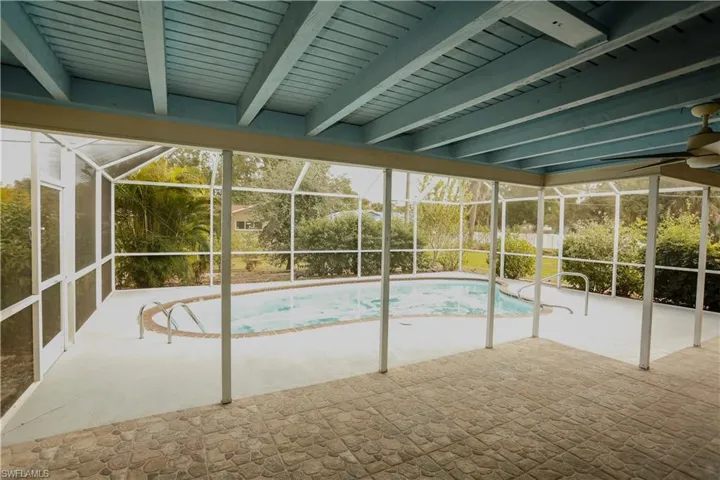 Outdoor pool with a lanai, a sunroom, and a patio
