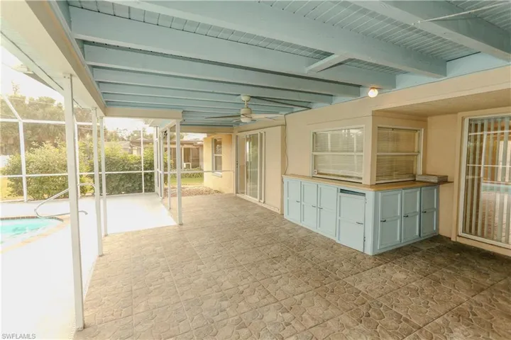 View of patio / terrace with a ceiling fan, a lanai, a sunroom, and an outdoor pool