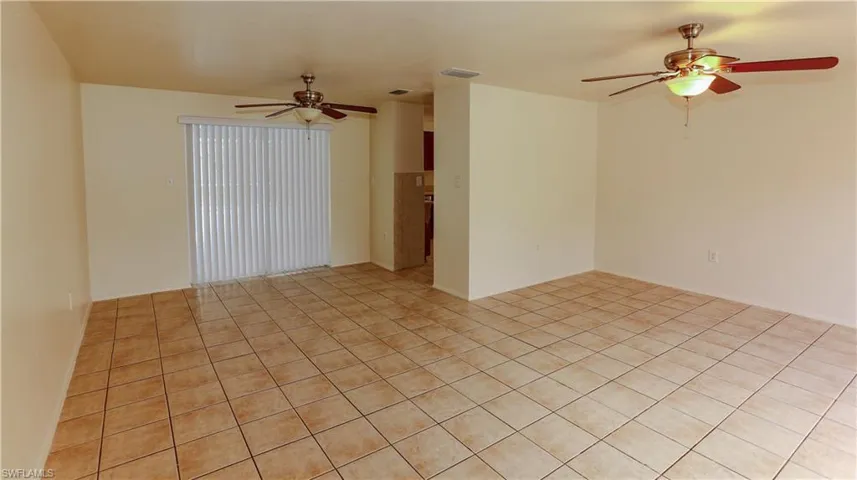 Spare room featuring ceiling fan and light tile patterned flooring