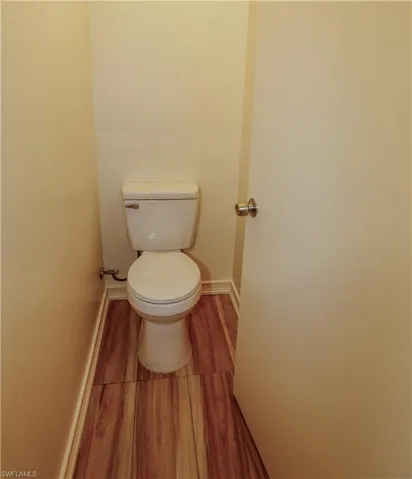 Bathroom featuring baseboards and wood finished floors