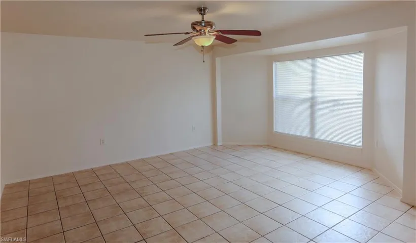 Spare room featuring a ceiling fan and tile patterned flooring