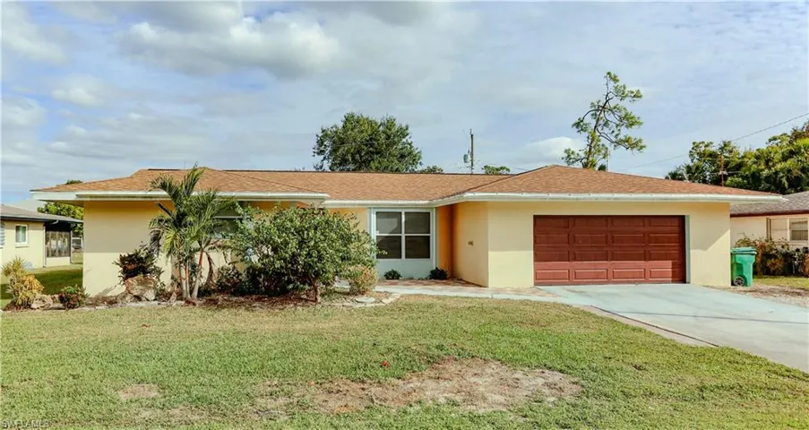 Single story home featuring stucco siding and a front lawn