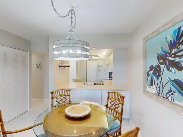 Tiled dining space with a textured ceiling