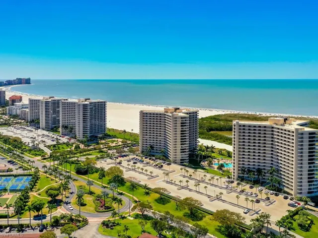 Birds eye view of property featuring a water view and a beach view