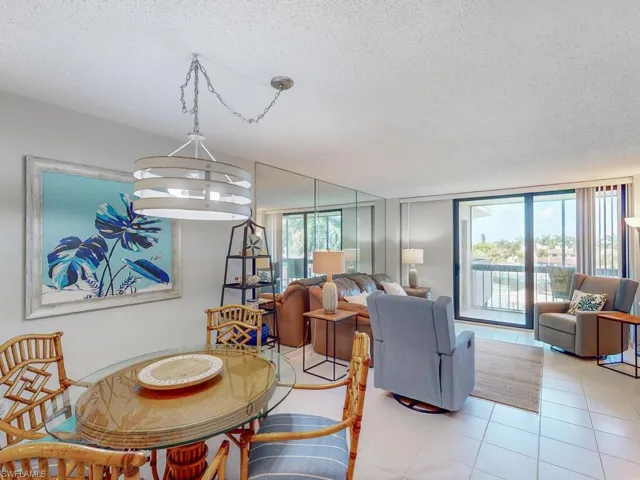 Dining space featuring a textured ceiling and light tile patterned floors