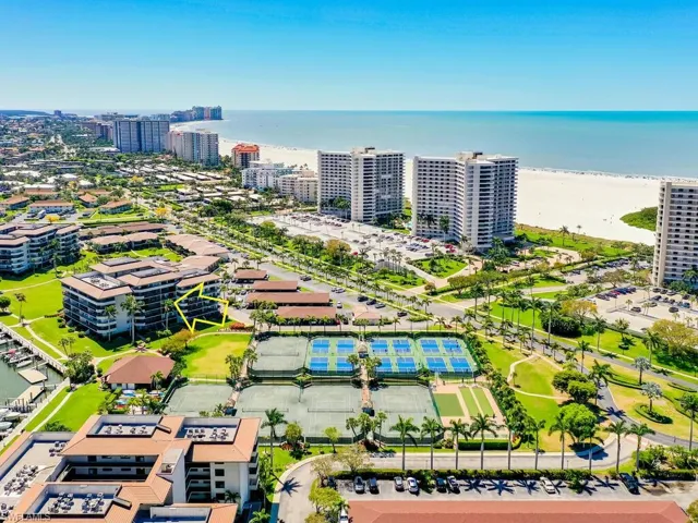 Aerial view featuring a water view and a view of the beach