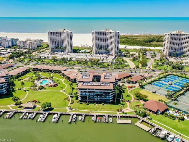 Birds eye view of property with a water view