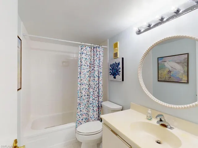Full bathroom featuring vanity, toilet, tile patterned floors, and shower / bath combo