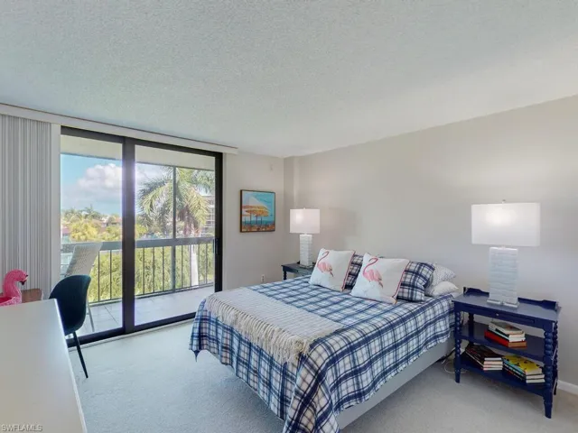 Carpeted bedroom featuring access to outside and a textured ceiling