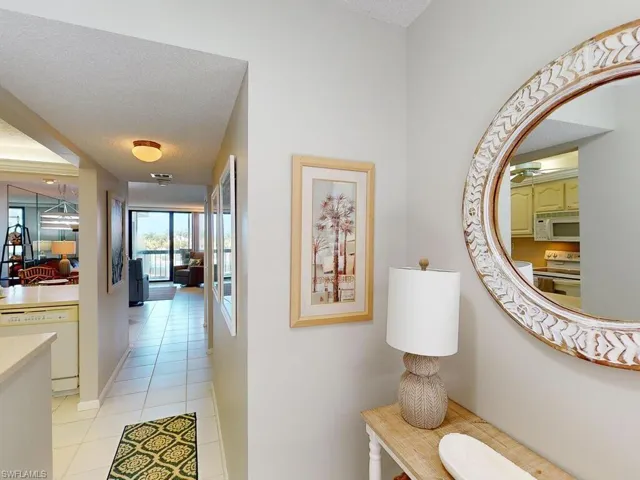 Corridor featuring light tile patterned floors and a textured ceiling