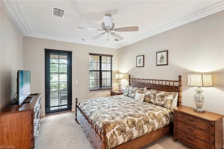 Bedroom with access to exterior, ceiling fan, light colored carpet, and ornamental molding