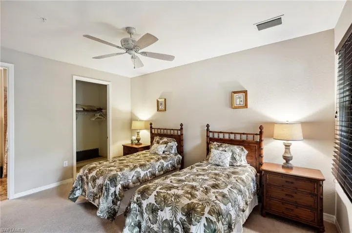 Bedroom featuring carpet flooring, a walk in closet, a closet, and ceiling fan