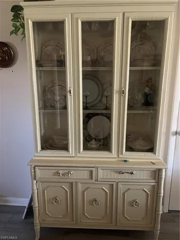 Built-in display cabinetry featuring glass-front doors, multiple shelving tiers, and integrated lower storage with paneled doors and drawer space