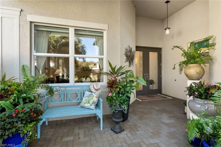 Inviting entry comes with thriving plants and bench that all conveys!