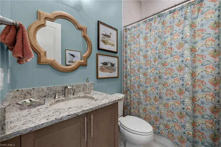 Second full bath between bedroom 2 +3 for your guests features floor to ceiling shower tile!....