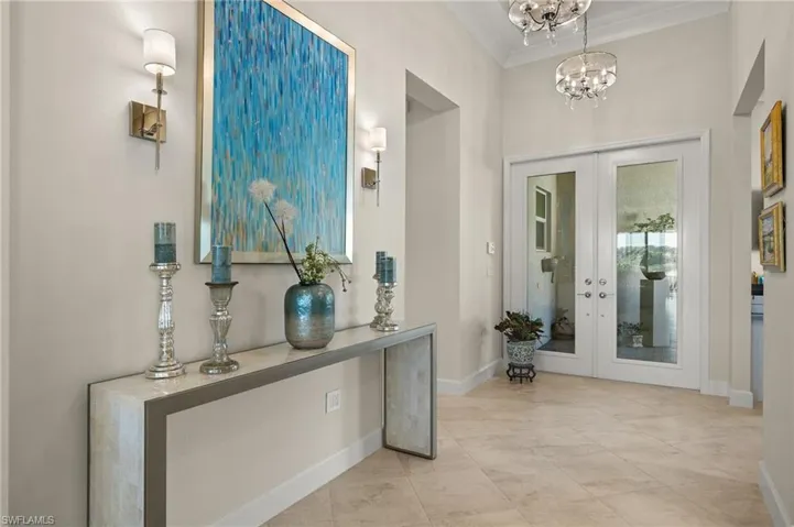 Foyer boasts 3 chandeliers, 2 sconces and wall art by local artist!