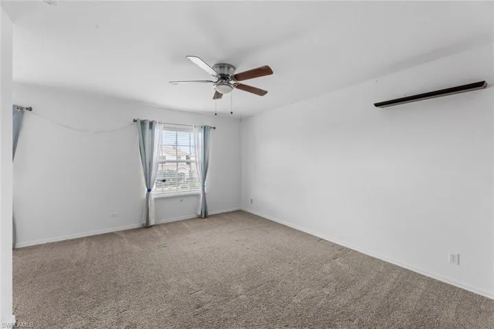 Master bedroom Carpeted empty room featuring ceiling fan