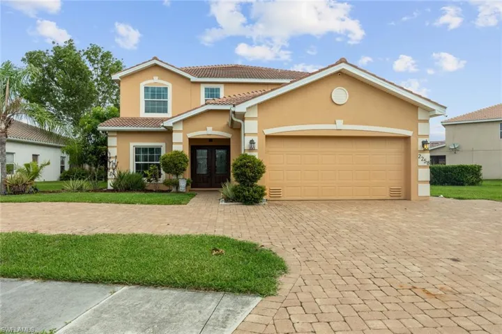 Mediterranean / spanish-style home with a garage
