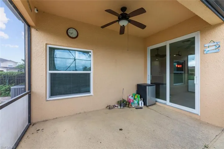 View of patio featuring central AC unit and ceiling fan