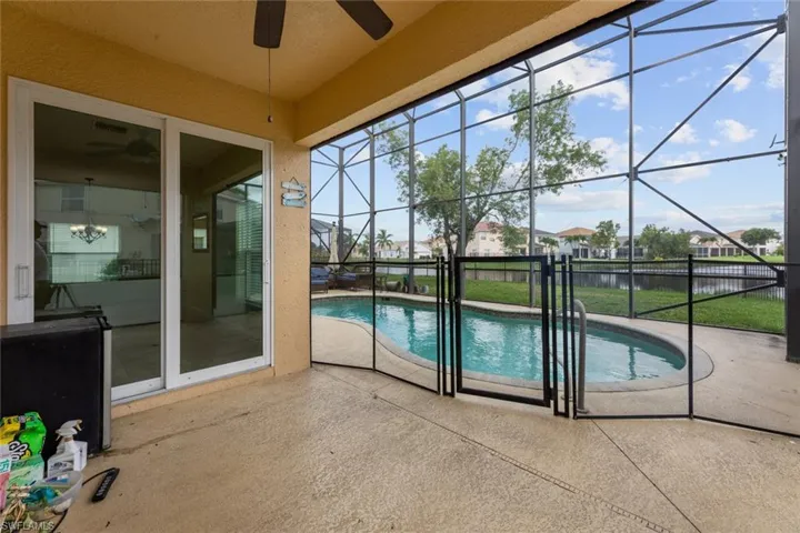 View of pool with a patio and ceiling fan