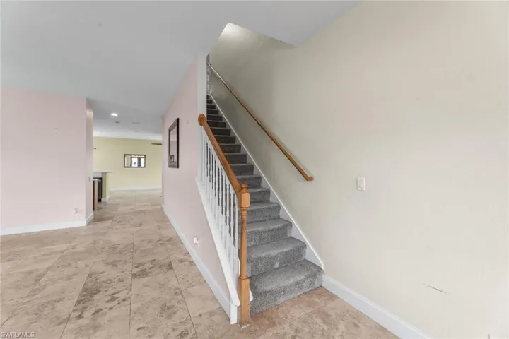 Stairs with light tile floors
