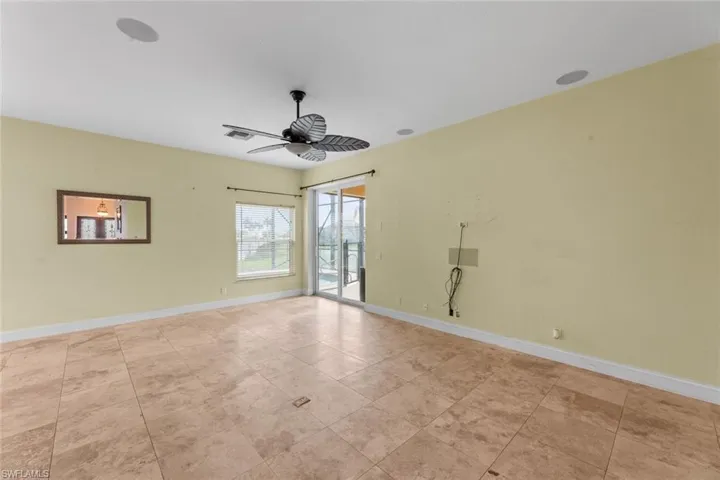 Tiled spare room with ceiling fan