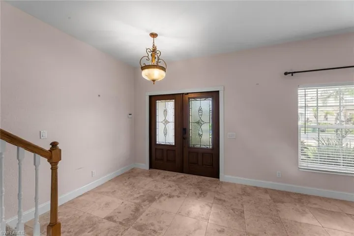 Tiled entryway featuring a wealth of natural light and french doors